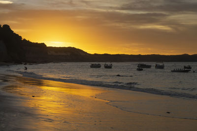 Scenic view of beach against sky during sunset