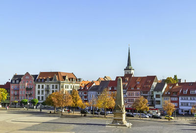 City street by buildings against sky