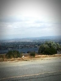 Scenic view of landscape against cloudy sky