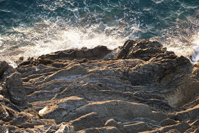 High angle view of waves breaking on rocks