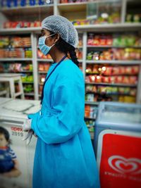 Side view of a woman standing in store