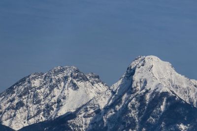 Scenic view of snowcapped mountains against clear blue sky