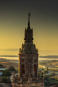 Traditional building against sky during sunset