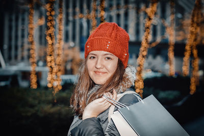 Portrait of smiling young woman in park during winter