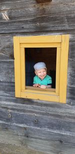 Cute boy peeking through window