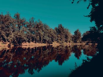 Reflection of trees in lake against sky