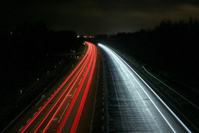 High angle view of traffic light trails on highway at night