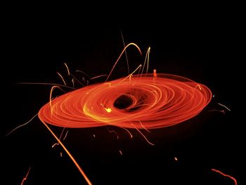 Close-up of light trails over black background