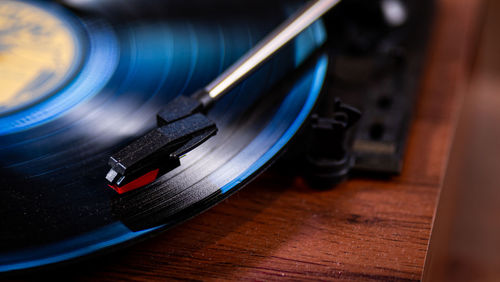 Record player needle macro view on wood table