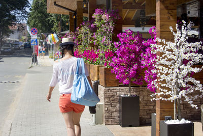 Rear view of woman walking on street