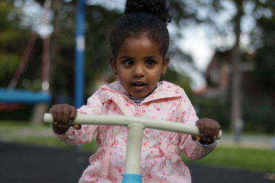 Cute girl playing on seesaw