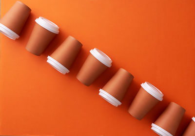 High angle view of electric lamps on orange table