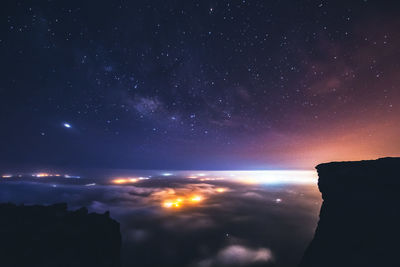 Scenic view of mountains against sky at night