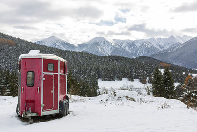 Red horse trailer in the mountain