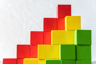 Stack of colorful wooden toy blocks on table