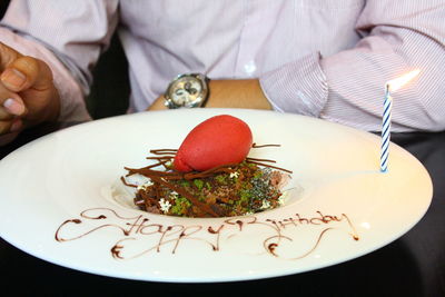 Close-up of hand holding cake