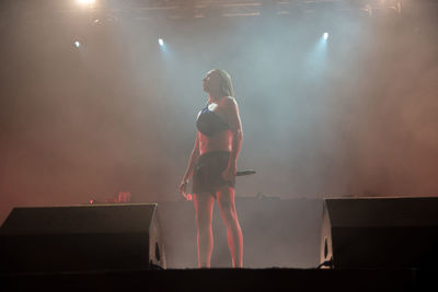Woman standing at music concert