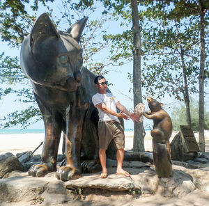 Full length of man standing against tree