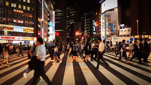 Pedestrians walking in shinjuku, tokyo, japan at night