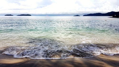 Scenic view of sea against cloudy sky