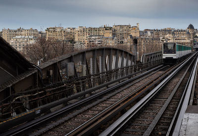 High angle view of railroad tracks in city against sky