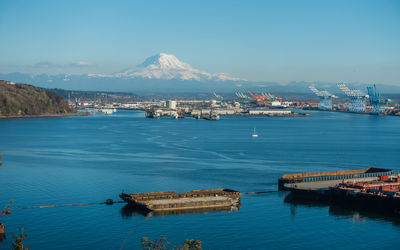 A view of the port of tacoma and mount rainier on a clear day.