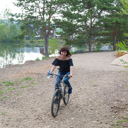 Rear view of woman riding bicycle