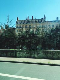 Buildings in city against clear sky