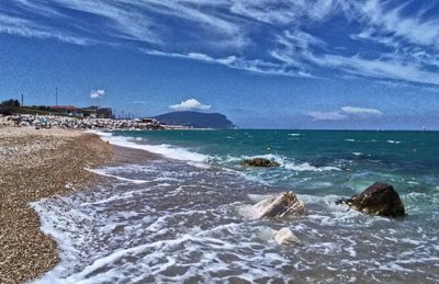 Scenic view of beach against blue sky