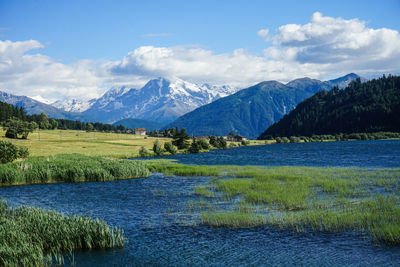 Scenic view of landscape and mountains against sky