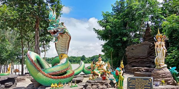 Statue of buddha against trees