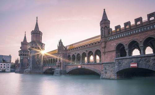 Oberbaumbrucke bridge over river during sunset