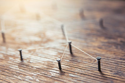 High angle view of barbed wire on wooden table