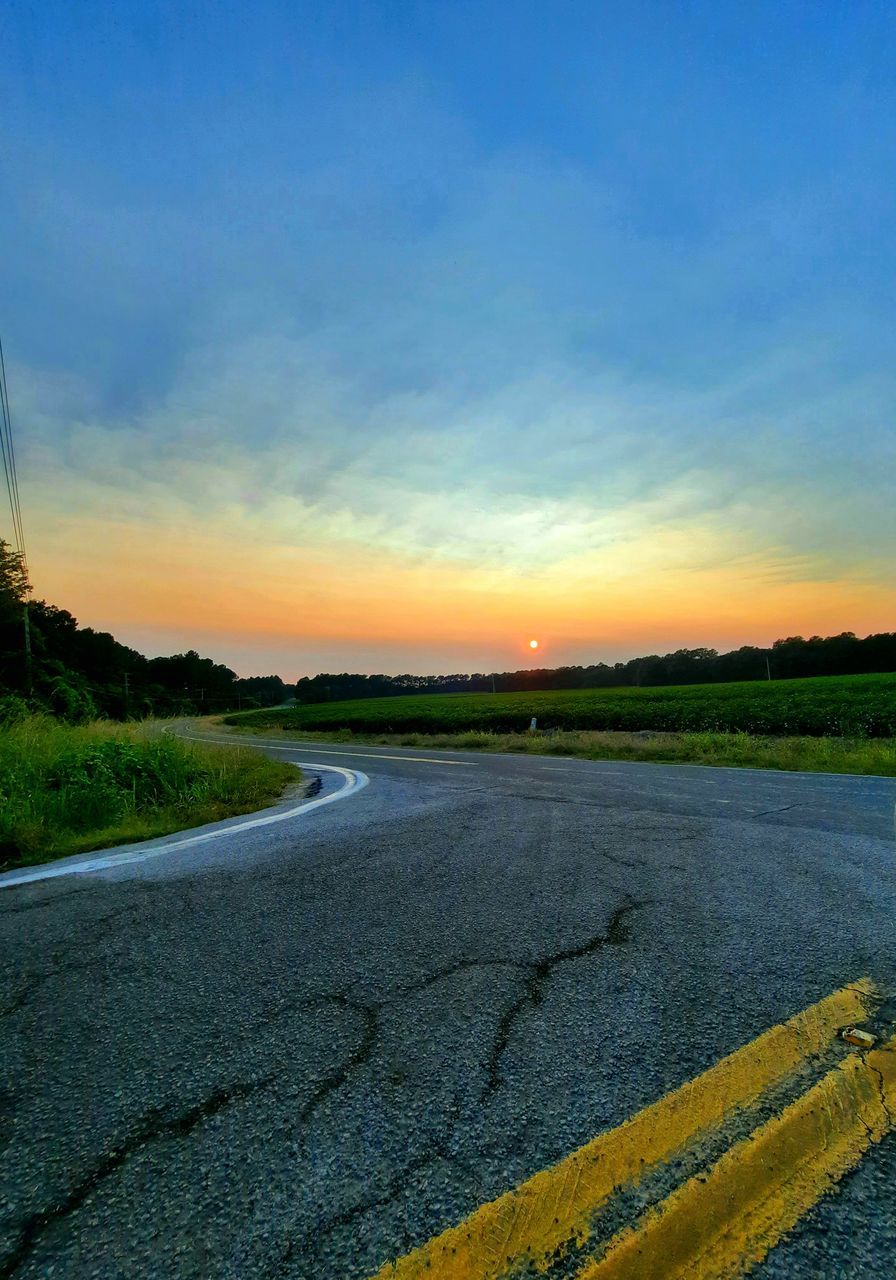 horizon, sky, morning, field, landscape, nature, road, plant, environment, dusk, sunrise, beauty in nature, plain, scenics - nature, no people, grass, rural area, sunlight, tranquility, tranquil scene, cloud, transportation, land, rural scene, agriculture, sea, outdoors, yellow, hill, asphalt, shore, coast, blue, non-urban scene, prairie, reflection, idyllic