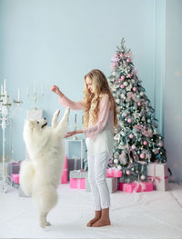 Full length of woman with cat