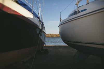 Boats moored in sea against sky