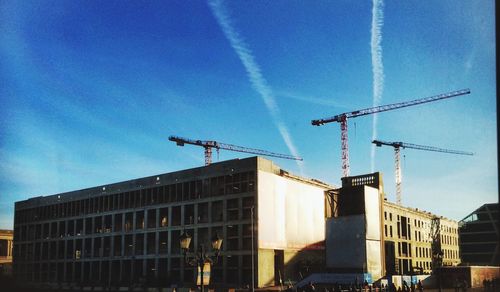 Low angle view of crane against sky