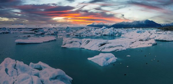 Scenic view of icebergs in jokulsarlon glacier lagoon, iceland, at dusk.