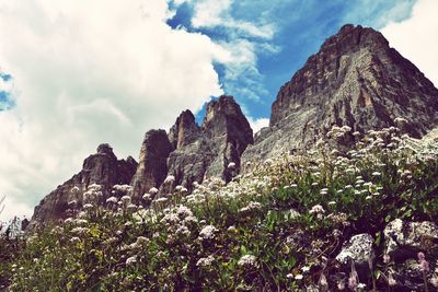 Low angle view of rocks on mountain against sky