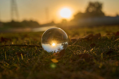 Close up of glass ball against sunset