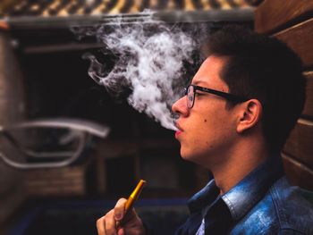 Close-up of young woman smoking