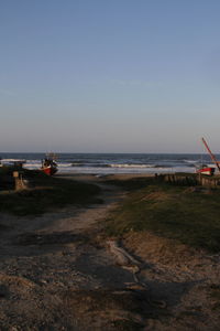 Scenic view of beach against clear sky