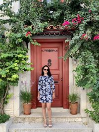 Full length of woman standing against building