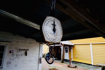 Low angle view of clock hanging on ceiling