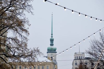 Low angle view of communications tower against sky