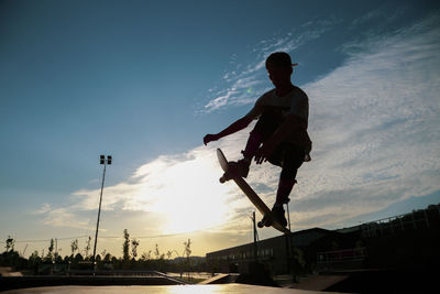 Low angle view of silhouette man against sky during sunset