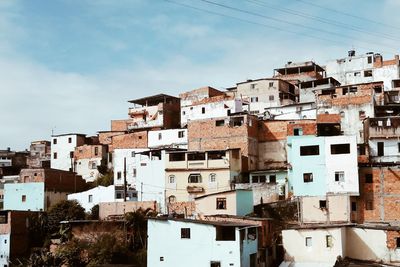 Houses in city against sky