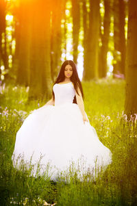 Portrait of beautiful woman standing in forest