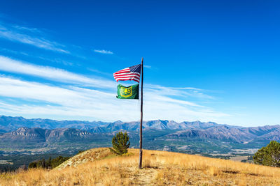 Scenic view of mountains against blue sky