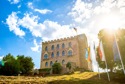 Low angle view of building against sky on sunny day